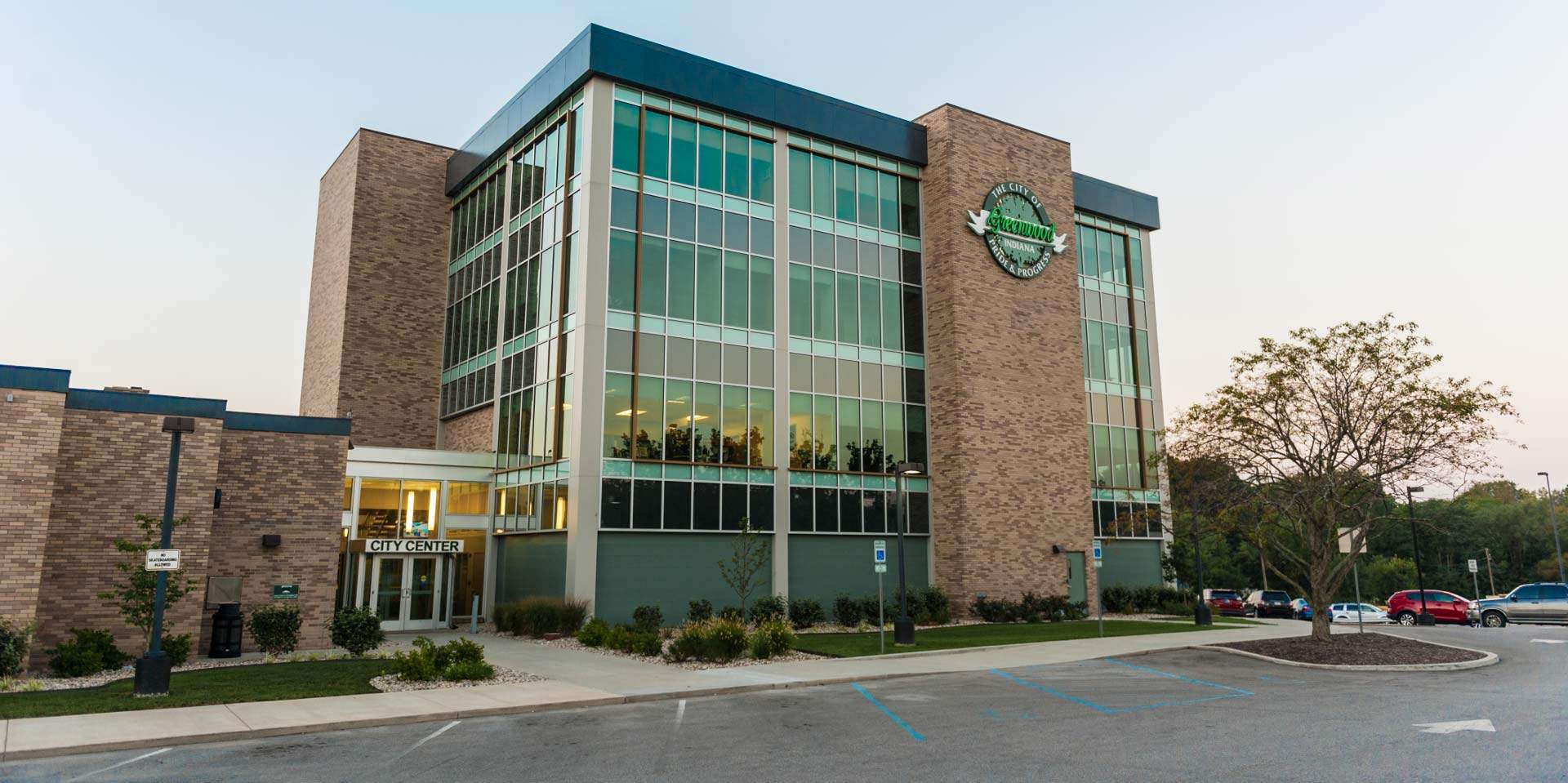 A modern, four-story brick and glass building with a 